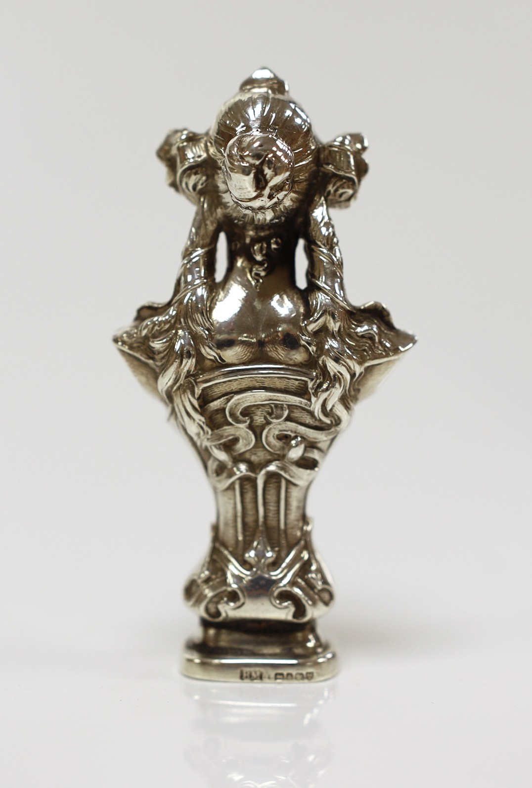 An early 20th century Art Nouveau silver seal, modelled as the bust of a lady, import marks for Berthold Muller, Chester, 1901, height 93mm, the matrix carved with family crest.
